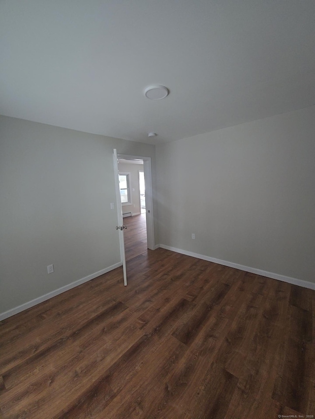 unfurnished room featuring dark hardwood / wood-style floors