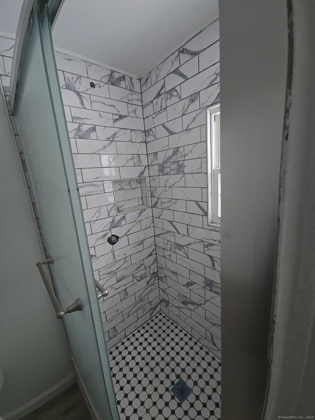 bathroom with a shower with shower door