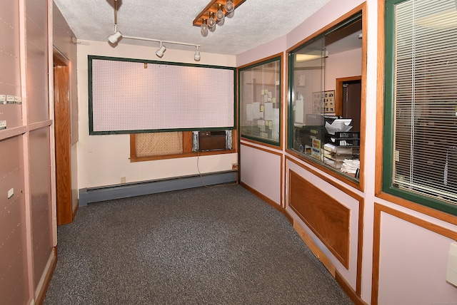 home theater featuring a baseboard radiator and a textured ceiling