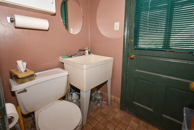 bathroom featuring toilet and tile flooring