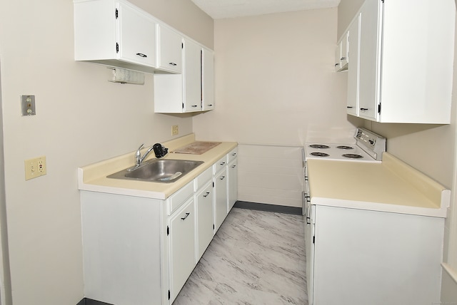 kitchen featuring white cabinets, sink, and light tile floors