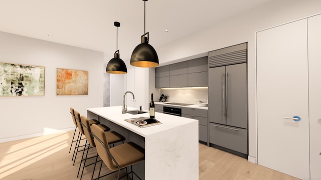 kitchen featuring black appliances, a kitchen breakfast bar, hanging light fixtures, gray cabinets, and light hardwood / wood-style floors
