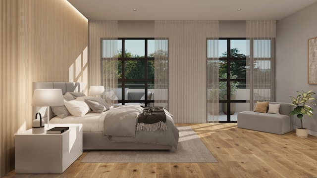 bedroom with light wood-type flooring and multiple windows