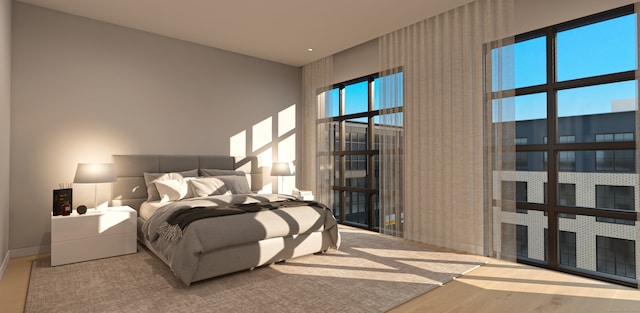 bedroom with wood-type flooring and multiple windows