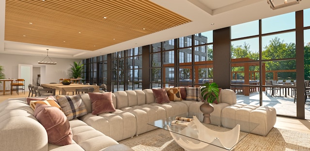 living room with a tray ceiling, light hardwood / wood-style flooring, wood ceiling, and a wall of windows