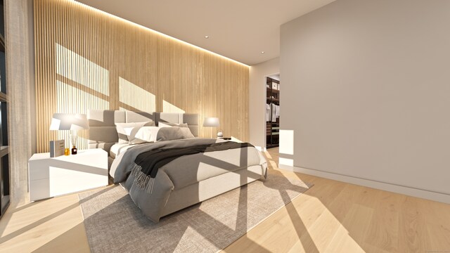 bedroom featuring wooden walls and light hardwood / wood-style flooring