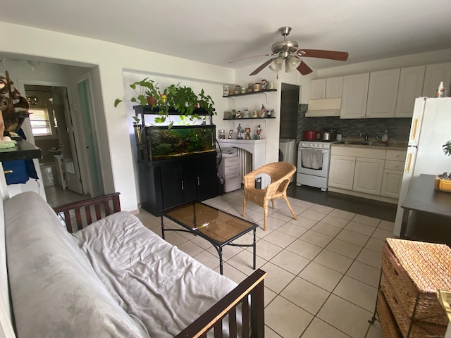 living room with sink, ceiling fan, and light tile floors