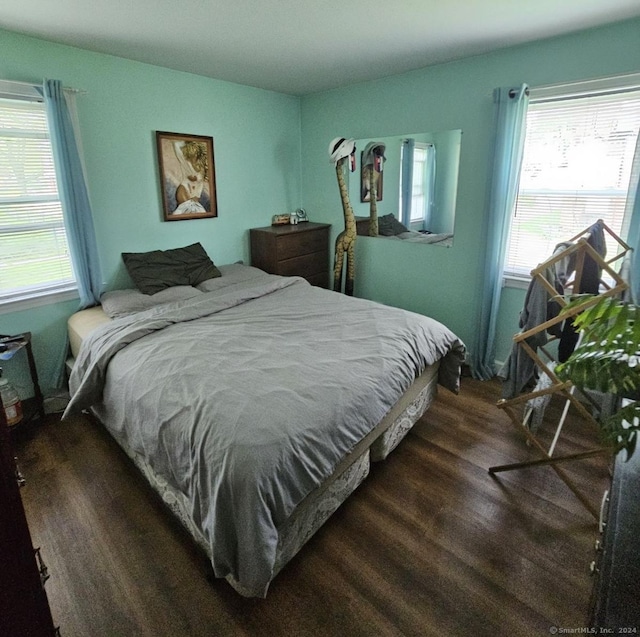 bedroom with dark hardwood / wood-style flooring