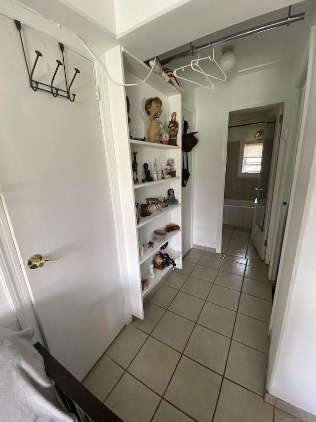 walk in closet with tile patterned floors