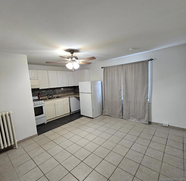 kitchen with radiator, white appliances, tasteful backsplash, ceiling fan, and white cabinets