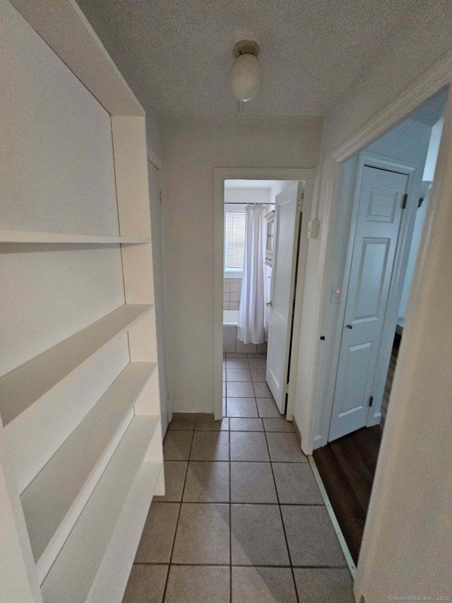 corridor with tile patterned flooring