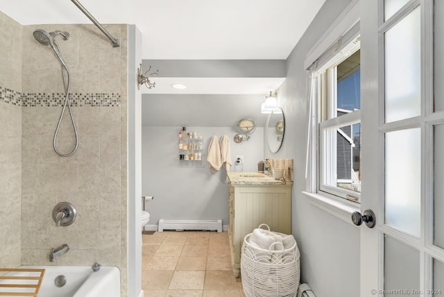 full bathroom featuring tiled shower / bath combo, toilet, vanity, tile patterned floors, and a baseboard heating unit