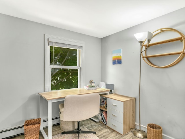 office area with a baseboard radiator and light wood-type flooring