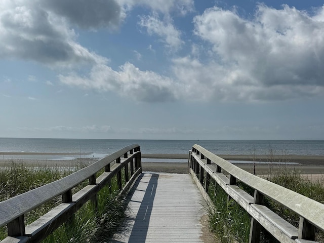 dock area featuring a beach view and a water view