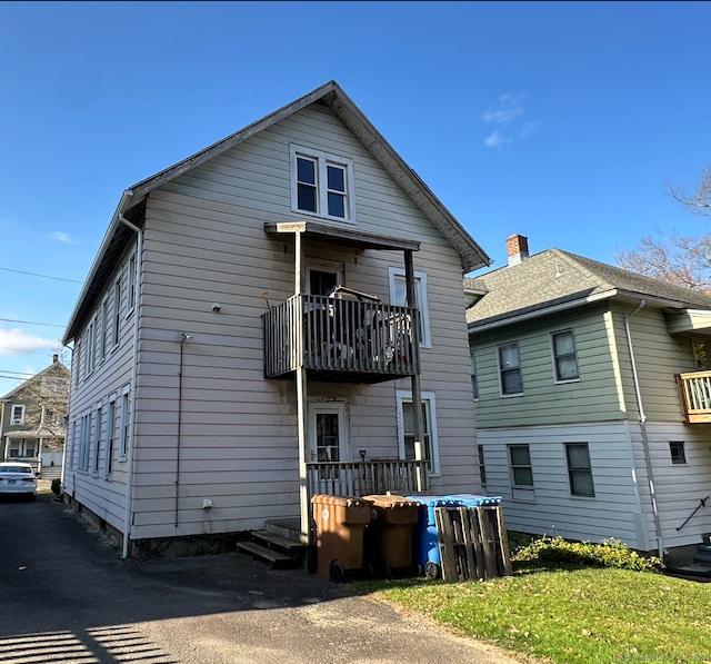 back of property featuring a balcony