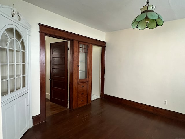 unfurnished dining area featuring dark hardwood / wood-style flooring