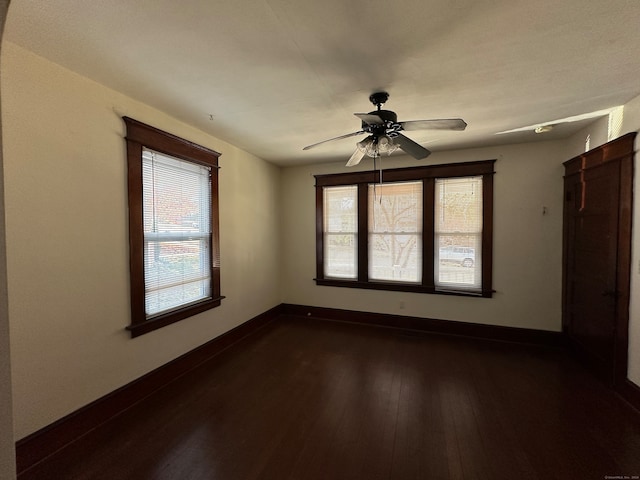 unfurnished room with dark wood-type flooring and ceiling fan