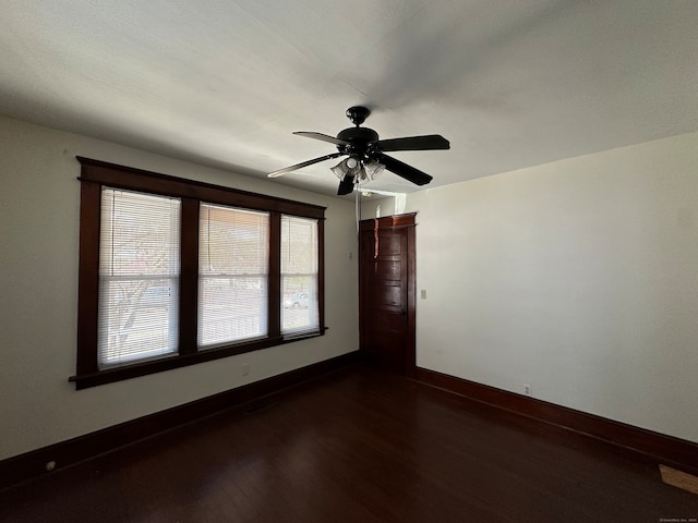 spare room featuring ceiling fan and dark hardwood / wood-style floors