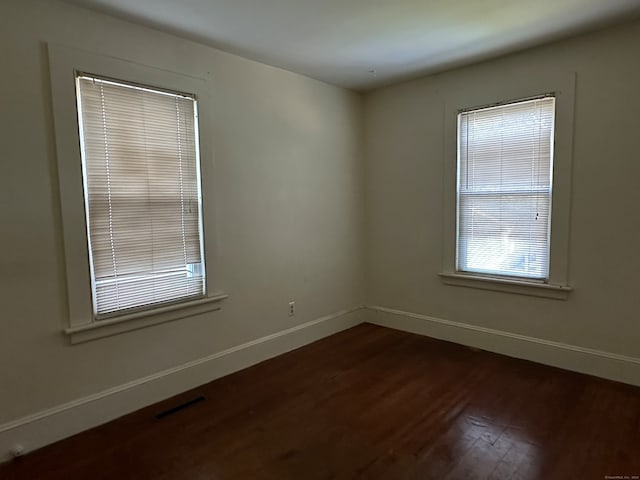 unfurnished room featuring dark hardwood / wood-style floors