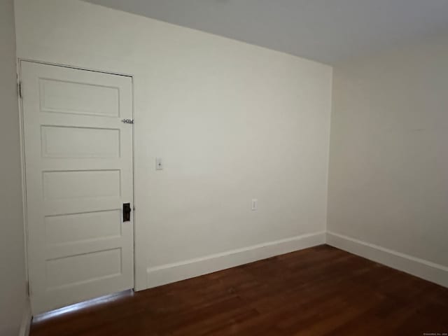 empty room featuring dark hardwood / wood-style flooring