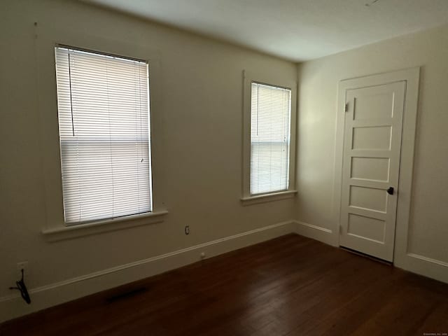 spare room featuring dark hardwood / wood-style floors