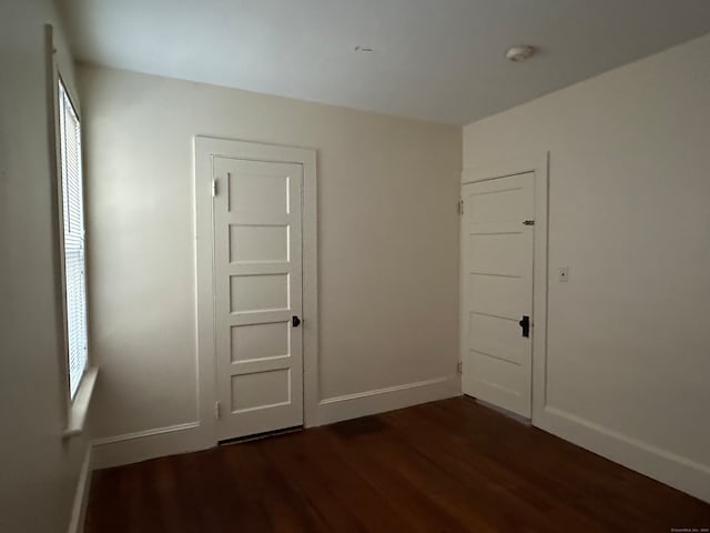 empty room with dark wood-type flooring