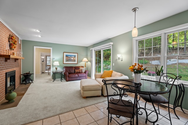 living room featuring a brick fireplace and light tile patterned flooring