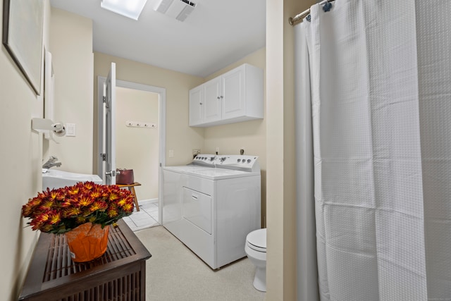 clothes washing area featuring light colored carpet and separate washer and dryer