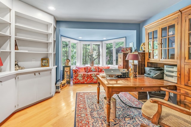 home office with light hardwood / wood-style floors