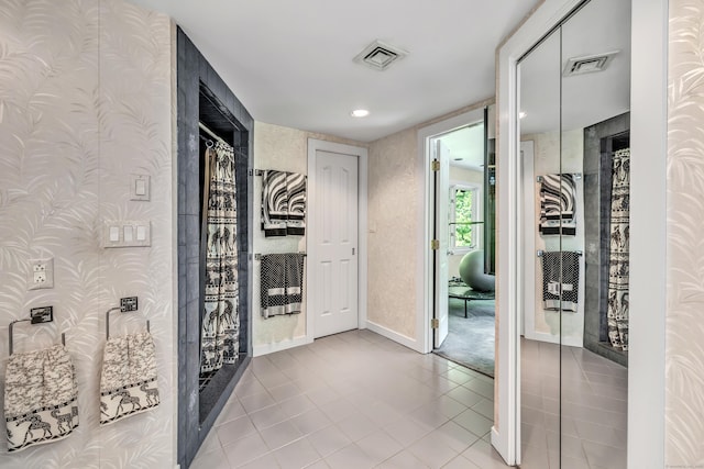 hall with light tile patterned flooring