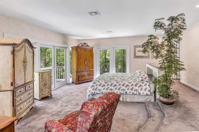 carpeted bedroom featuring french doors and access to outside