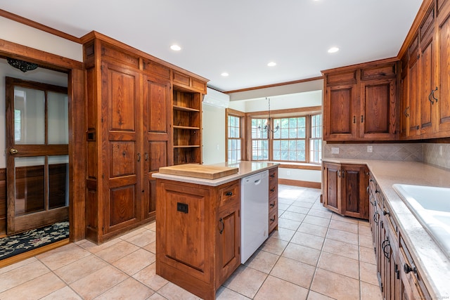 kitchen featuring a center island, white dishwasher, a wall mounted AC, backsplash, and light tile flooring