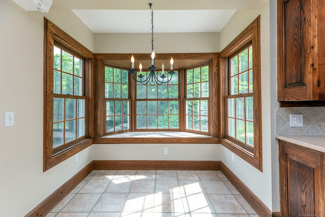 unfurnished dining area featuring an inviting chandelier and light tile floors