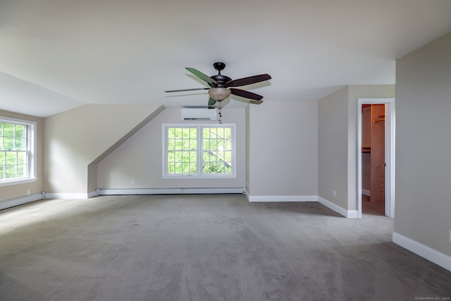 additional living space featuring a wealth of natural light, carpet flooring, ceiling fan, and an AC wall unit