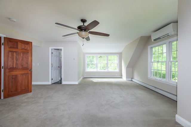 spare room with a baseboard heating unit, a wall unit AC, carpet floors, and ceiling fan