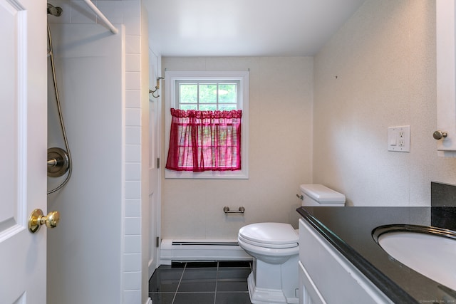 bathroom featuring tile flooring, baseboard heating, toilet, and vanity