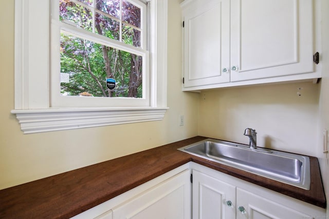 kitchen featuring white cabinets and sink