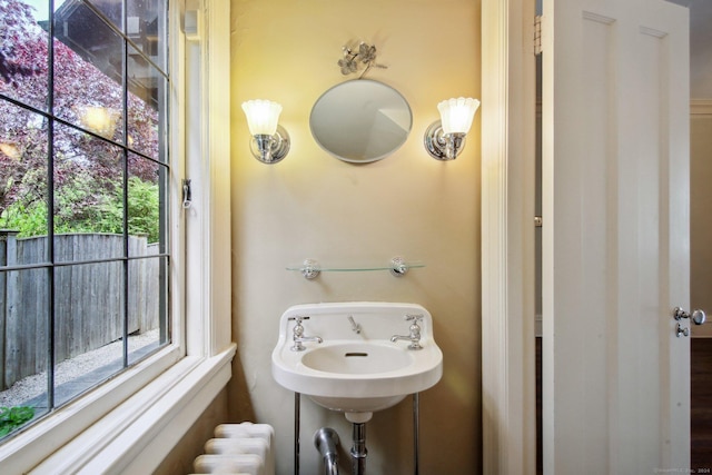 bathroom with sink and radiator