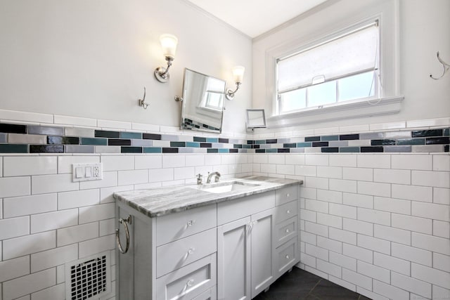 bathroom featuring tile patterned flooring, vanity, tile walls, and ornamental molding