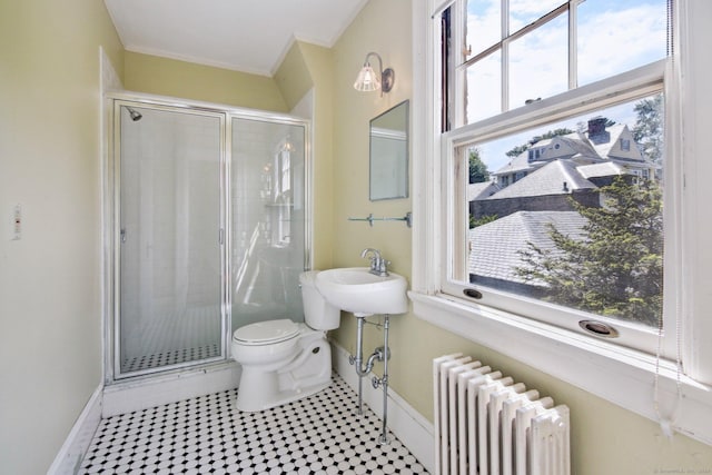 bathroom featuring radiator, tile patterned floors, sink, toilet, and a shower with shower door