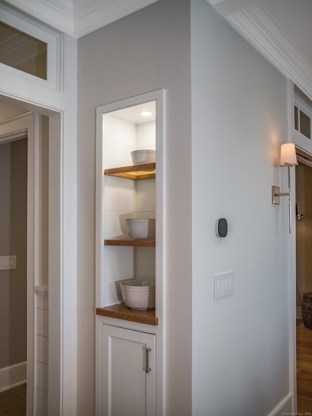 hallway featuring hardwood / wood-style floors and ornamental molding