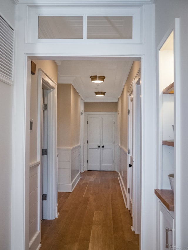 hallway with hardwood / wood-style floors