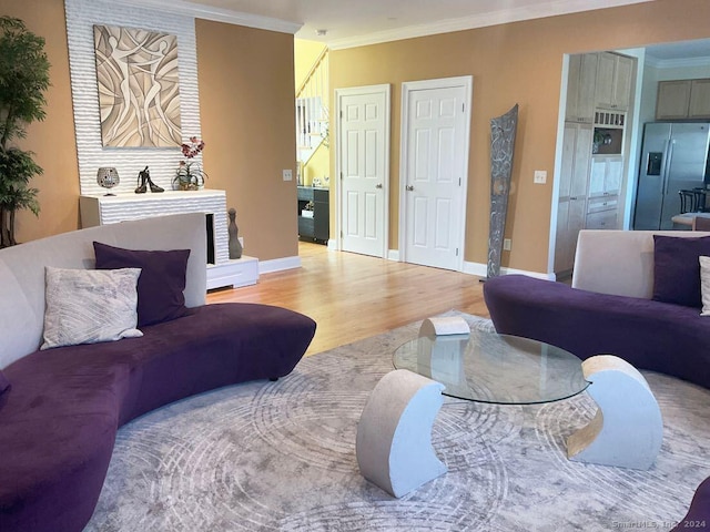 living room with crown molding and light hardwood / wood-style flooring