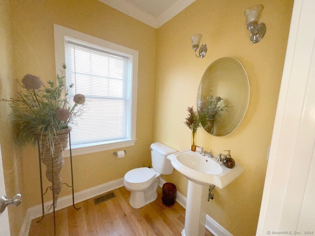 bathroom featuring hardwood / wood-style flooring and toilet