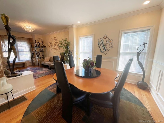 dining room featuring crown molding and light hardwood / wood-style floors