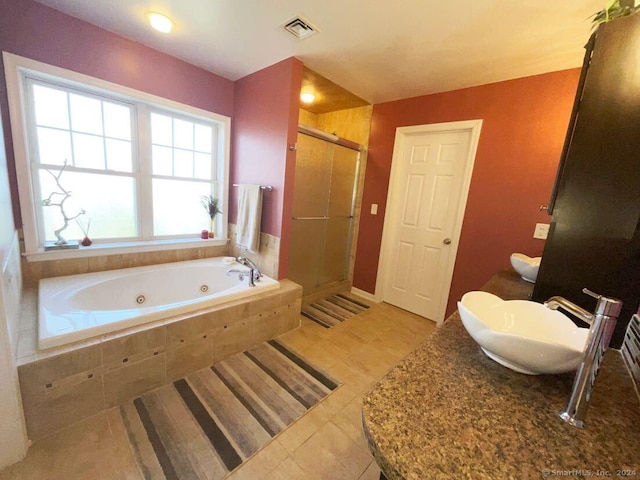 bathroom featuring sink, tile patterned floors, and independent shower and bath