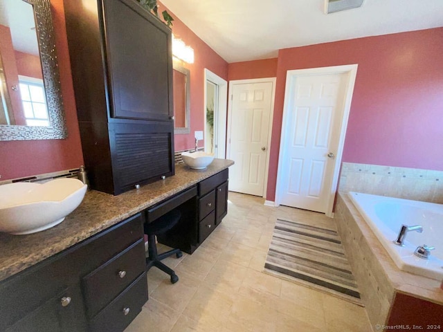 bathroom featuring vanity and tiled bath