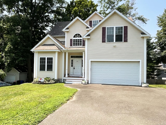 view of front of home with a garage and a front lawn