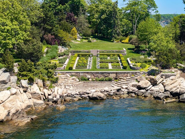 exterior space featuring a water view and a lawn