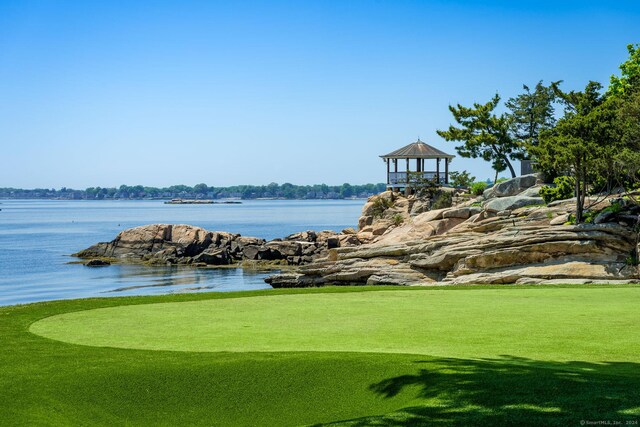 view of property's community featuring a yard, a water view, and a gazebo